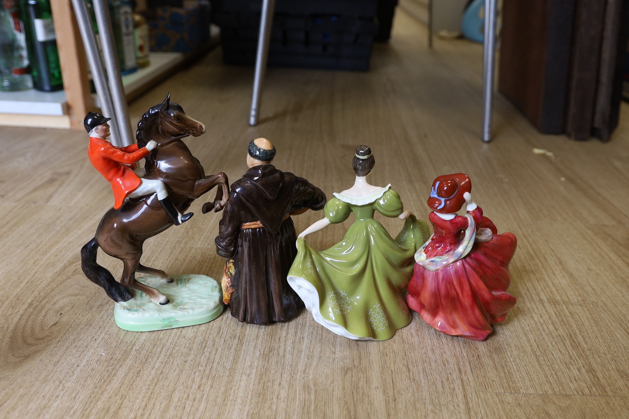 A Beswick figure group of a rearing horse and rider, a Doulton figure, The jovial monk, Top o’ the Hill and Lynne.